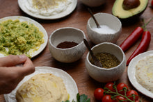 Charger l'image dans la galerie, Collection Islande de Marianne Chemla (m céramique): Pot pincé "Islande" Un pot créé à partir d’une boule de porcelaine, en pinçant l’argile avec les doigts. Peut être utiliser pour le thé, les épices, entre autres. Fait à la main, chacun est unique. Blanc doux avec un pigment gris ou de manganèse. Porcelaine cuite à 2232 °F.